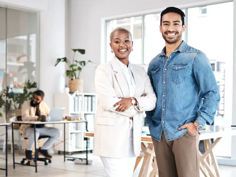 Confident entrepreneurs pose in a bright studio after boosting their reach through our business directory